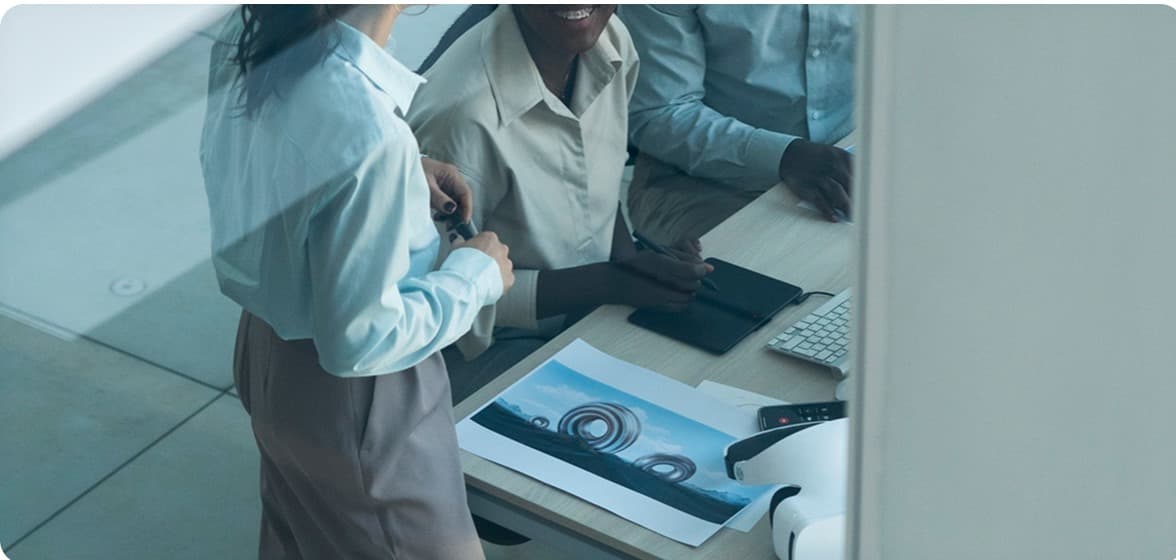 A team discussing printed strategy documents